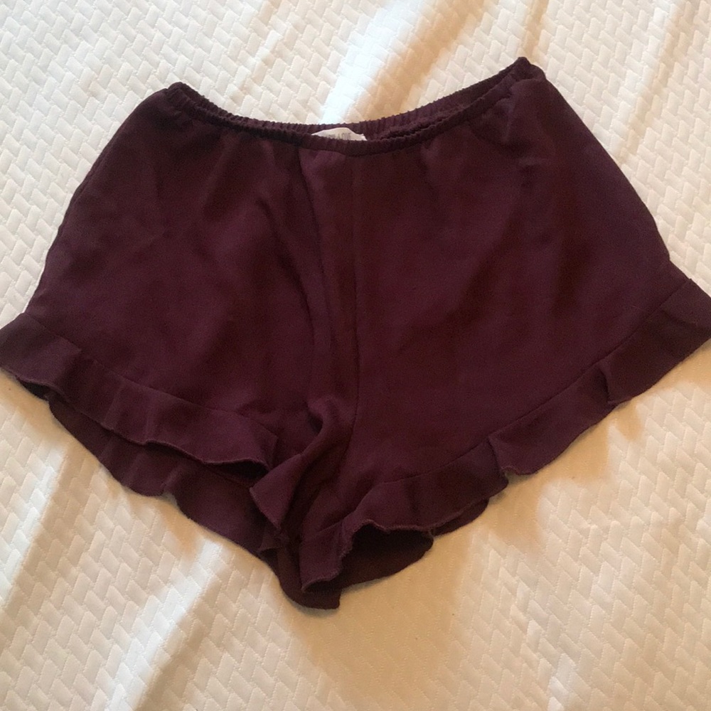 Maroon dress shorts with ruffles.